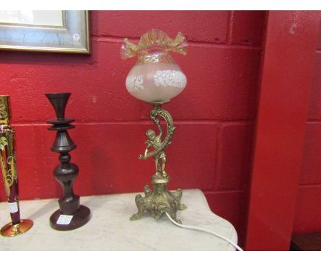 A gilt metal figural lamp with glass shade 