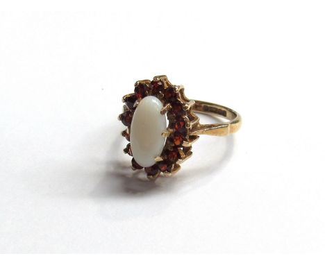 A 9ct gold oval opal and garnet dress ring 