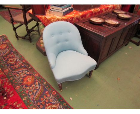 A Victorian walnut button back open armchair the serpentine front seat over turned and tapering legs on brass castors 