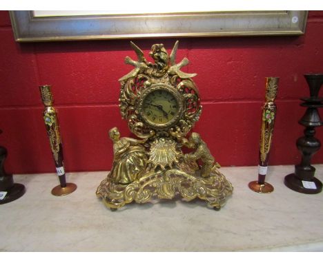 A gilded metal mantel clock with Victorian couple and dove design