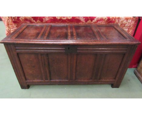 Circa 1700 an oak four panel coffer, the rising lid over stile feet 