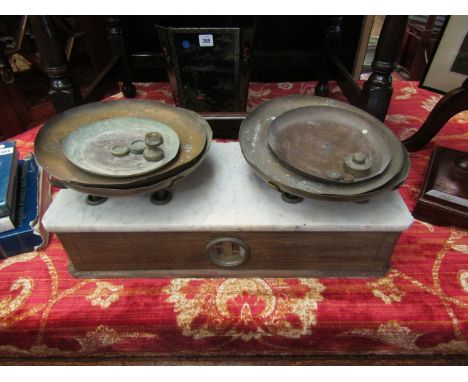 A French bygone set of retailer's scales, oak base, marble top, integral weighing system and brass weights 