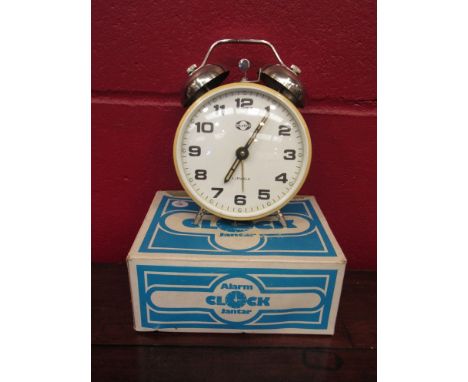 A boxed Jantar alarm clock