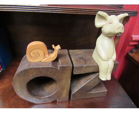 Two carved wood 3D letters, a pig shelf figurine and a snail puzzle (4)