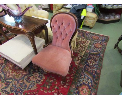 Circa 1860 a walnut buttoned spoon back-rest chair on turned legs and white ceramic castors 