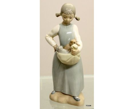 A Nao figure of a  girl with kittens, measuring 23cm