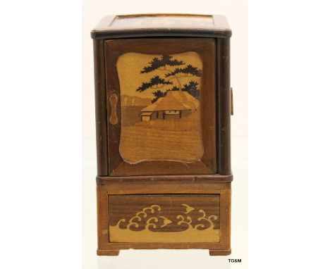 A vintage marquetry inlaid rosewood table top smokers  cabinet consisting of 4 door and a 4 way drawer depicting Oriental sce