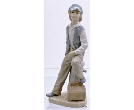 A Nao figure 'The shoe shine boy'. 26cm high