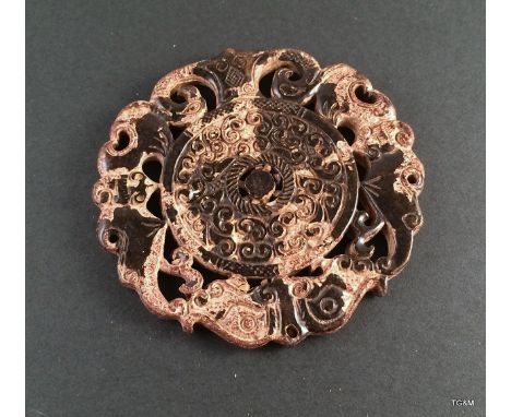 A well carved Chinese Jade Bi. 7cm diameter