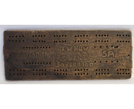 A Boer War trench art wooden cribbage board with carved inscription TW Huw Ladysmith SA 30 Feb 1900. 28cms x 110cms
