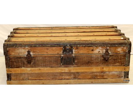 A wooden banded travelling trunk 110 x 55 x 35cm