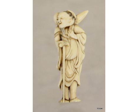 C19th Japanese carved ivory netsuke of old man with walking stick and sack to shoulders. 68mm high
Condiiton report
The item 