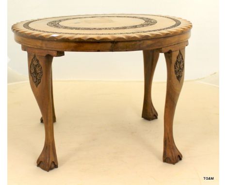 A walnut lamp table on claw feet with pie crust top and carved surround 43 x 60cm