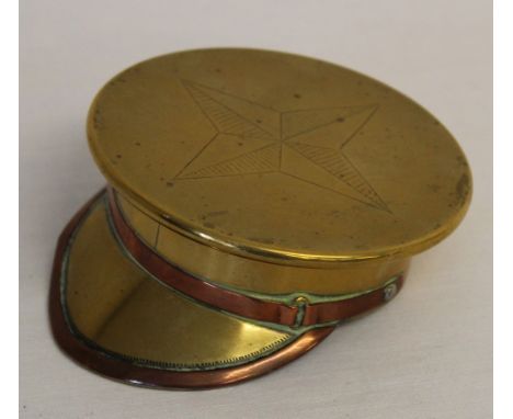 A superb WW1 trench art snuff box or ashtray made from a brass shell case in the form of an officer cap with inscription AJB 