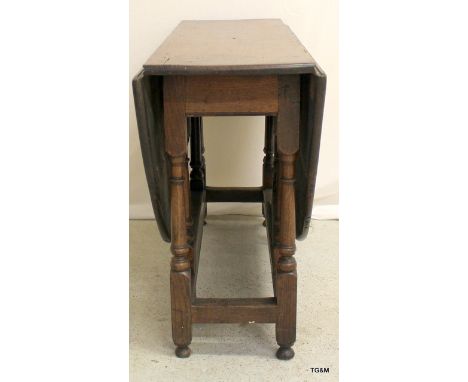 A 17th century gate leg oak drop leaf table with 2 drawers