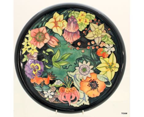 A Moorcroft carousel charger designed by R Bishop 36cm in diameter