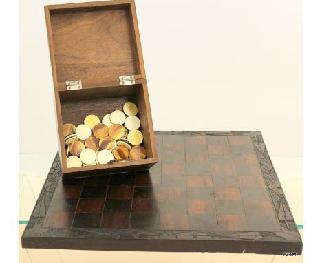 An Oriental checkers set with boxed set of counters