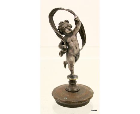 Silvered bronze car mascot of dancing cherub with ribbon
