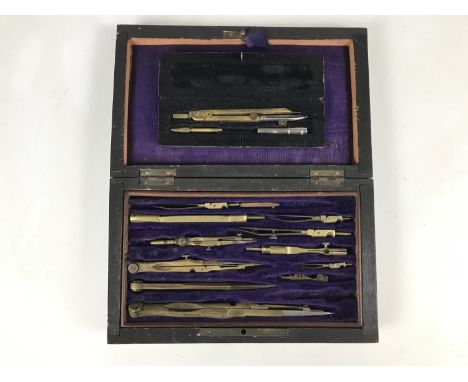 A cased drawing instruments set together with a cased compass