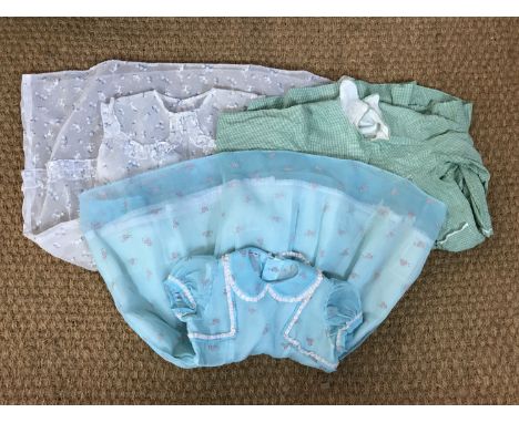 Three 1960s girls' dresses, including a Dainty Dot organdie party dress in turquoise blue, decorated with a sprigged and floc