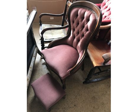 A contemporary mahogany button back nursing chair with conforming footstool