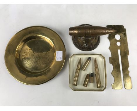 A Great War trench art paperweight, a Black Watch brass ashtray, a button stick bearing Black Watch issue stamps and a paperw