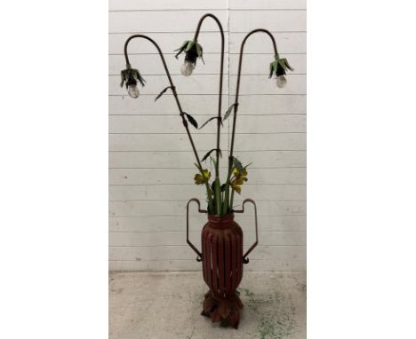 A industrial style wrought iron floor standing standard lamp with three arms in the form of  a plant in a two handled vase. H