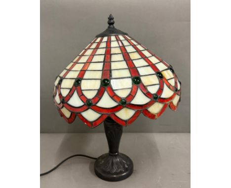 An Art Deco style lamp with Tiffany style shade in white red and green stained glass 