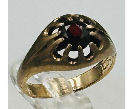 A 9ct gold and garnet ring in a claw setting, approximate size K.5 Approximate weight 2.9g