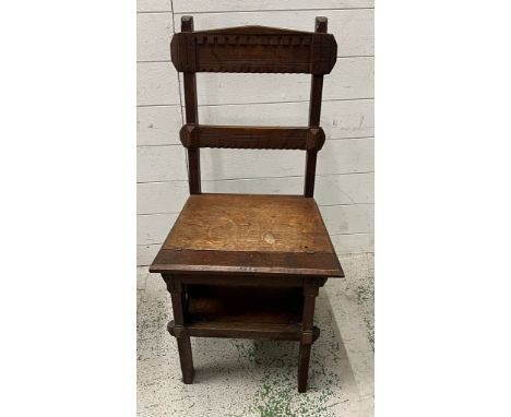 An oak metamorphic library chair opening to step ladders 