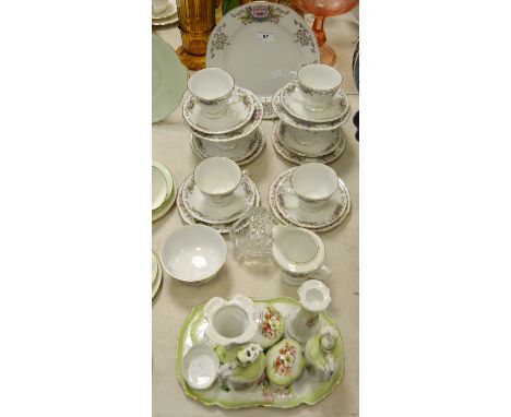 A Continental porcelain dressing-table set, probably German, printed with winter flowers, comprising shaped tray, pair of can