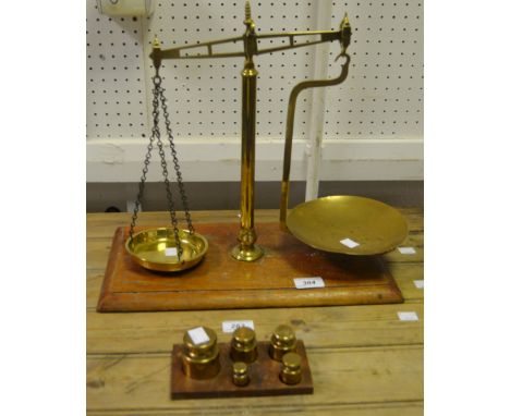 A shop counter brass scale and weights