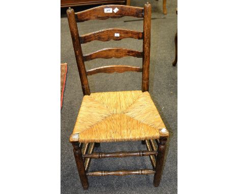 An oak North Country ladder back chair with rush seat