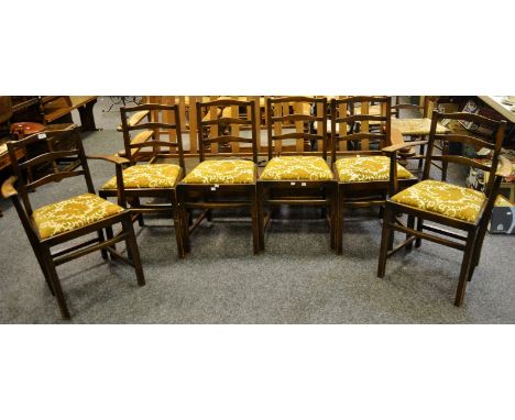 A set of six oak ladder back  dining chairs including two carvers drop in seats.