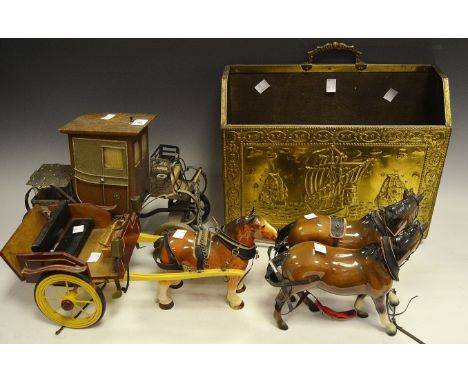 A Melba Ware Pony and Trap; another similar carriage enclosing drinking glasses ; a brass magazine rack 