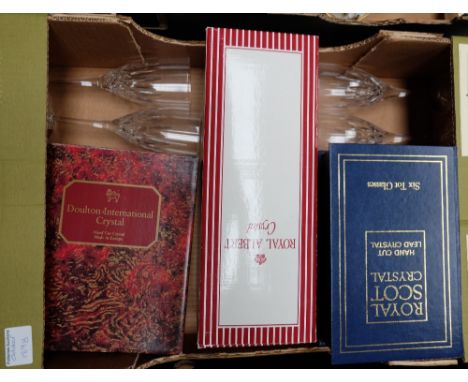 A collection of boxed quality crystal glassware to include Royal Doulton champagne flutes, Royal Albert decanter and Royal Sc