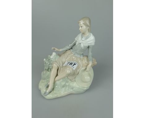 Nao figure of Woman seated on rock holding hat height 21cm