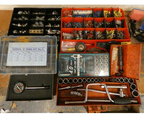 A compression tester, a socket set, a tap and die set a quantity of bulbs and other tools. 