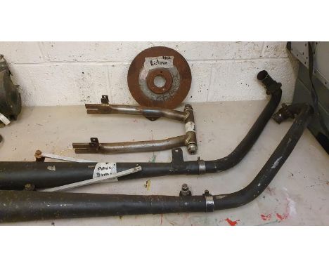 A believed Dunstall swinging arm for a Norton Featherbed, together with a pair of megaphone silencers and a front disc. 