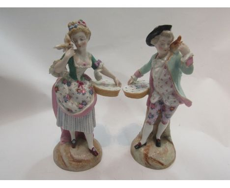 A pair of Continental ceramic figurines depicting lady and gent with flower baskets, marks to base