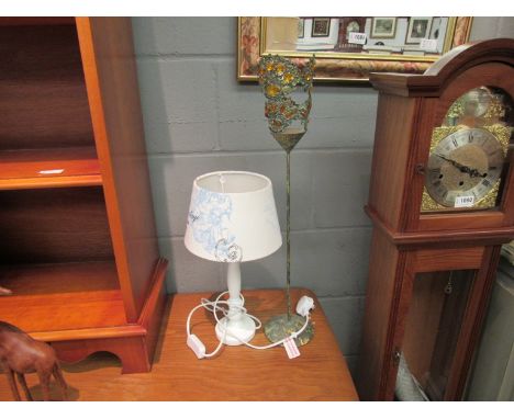 A Shabby-Chic style bedside table lamp with white and blue linen shade and an Eastern style free-standing tea-light holder