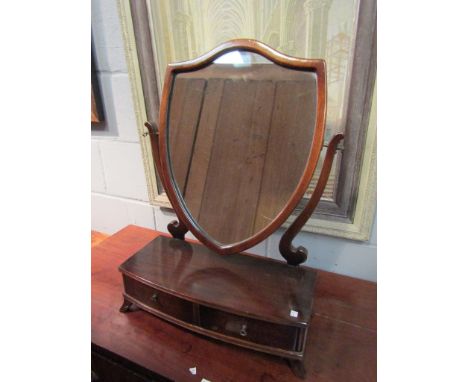 A mahogany shield form dressing table mirror with two drawers       