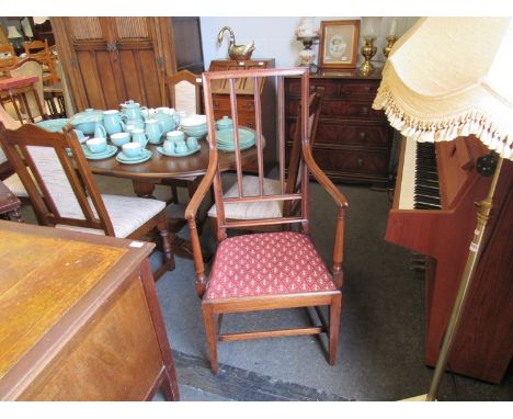 An oak stick-back high armchair with stretcher base