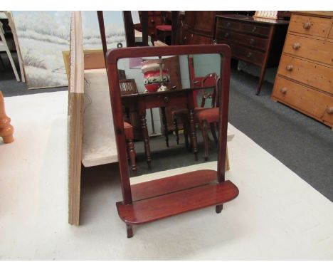 A late 19th Century mahogany wall mirror with integrated shelf and rail, 84cm x 56cm
