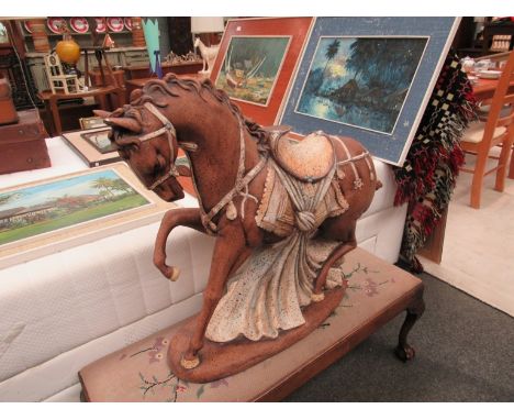 A decorative ceramic figure of a stallion horse with foot raised, 68cm high