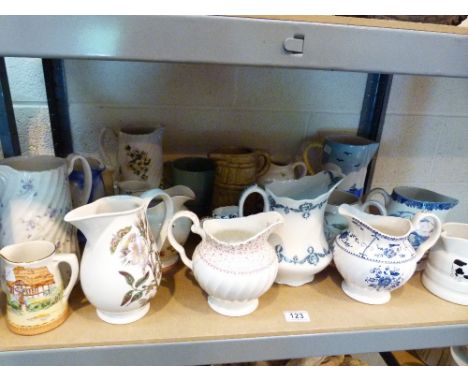 Shelf of mixed maker ceramic jugs 