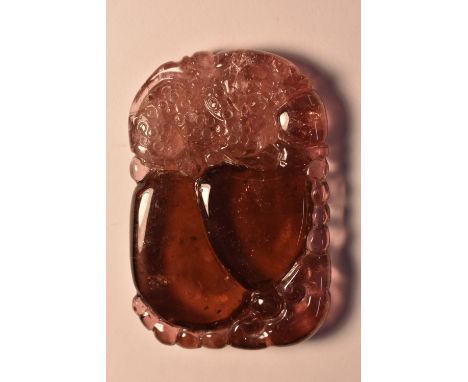 A red tourmaline carved tablet panel, mythical beast and fruit, estimared stone weight approx 115ct, 46mm x 30mm, 23.1g