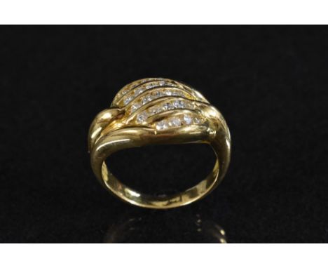 A diamond panel ring, shaped five row crest, inset with twenty three round brilliant cut diamonds, total estimated diamond we