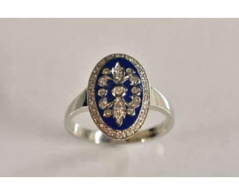 An Art Deco style diamond enamel ring, oval diamond encrusted swags raised above a blue enamel ground, set within an 18ct whi