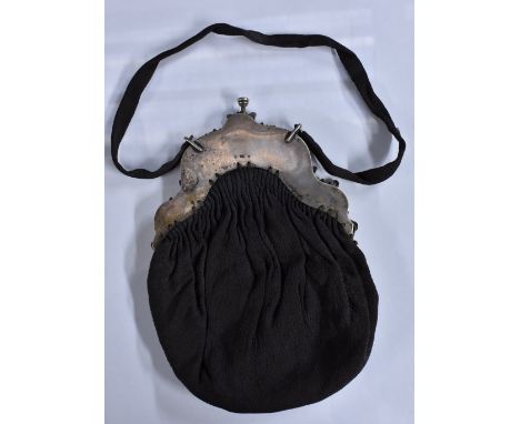 A 19th Century French silk evening bag, cast silver mounts depicting cherubic children playing musical instruments amid fruit